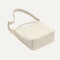 The Bucket Bag in White Sand shown laid down.