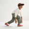 Alternate view of a model wearing The Kids Strap Sneaker in Watermelon. 