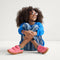 Alternate view of a model wearing The Kids Strap Sneaker in Watermelon. 
