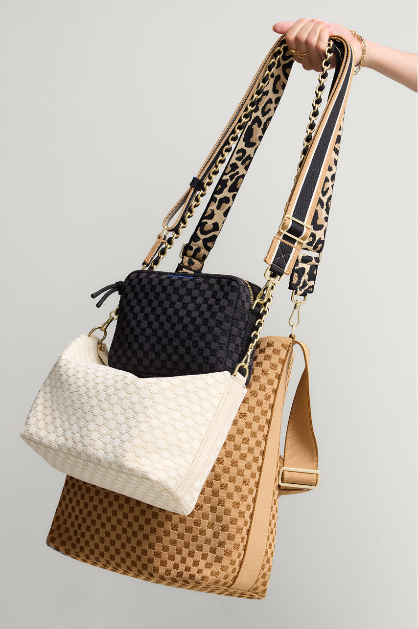 Collection shot of the camera bag, the bucket bag, and crossbody bag, with a variety of chain straps. 