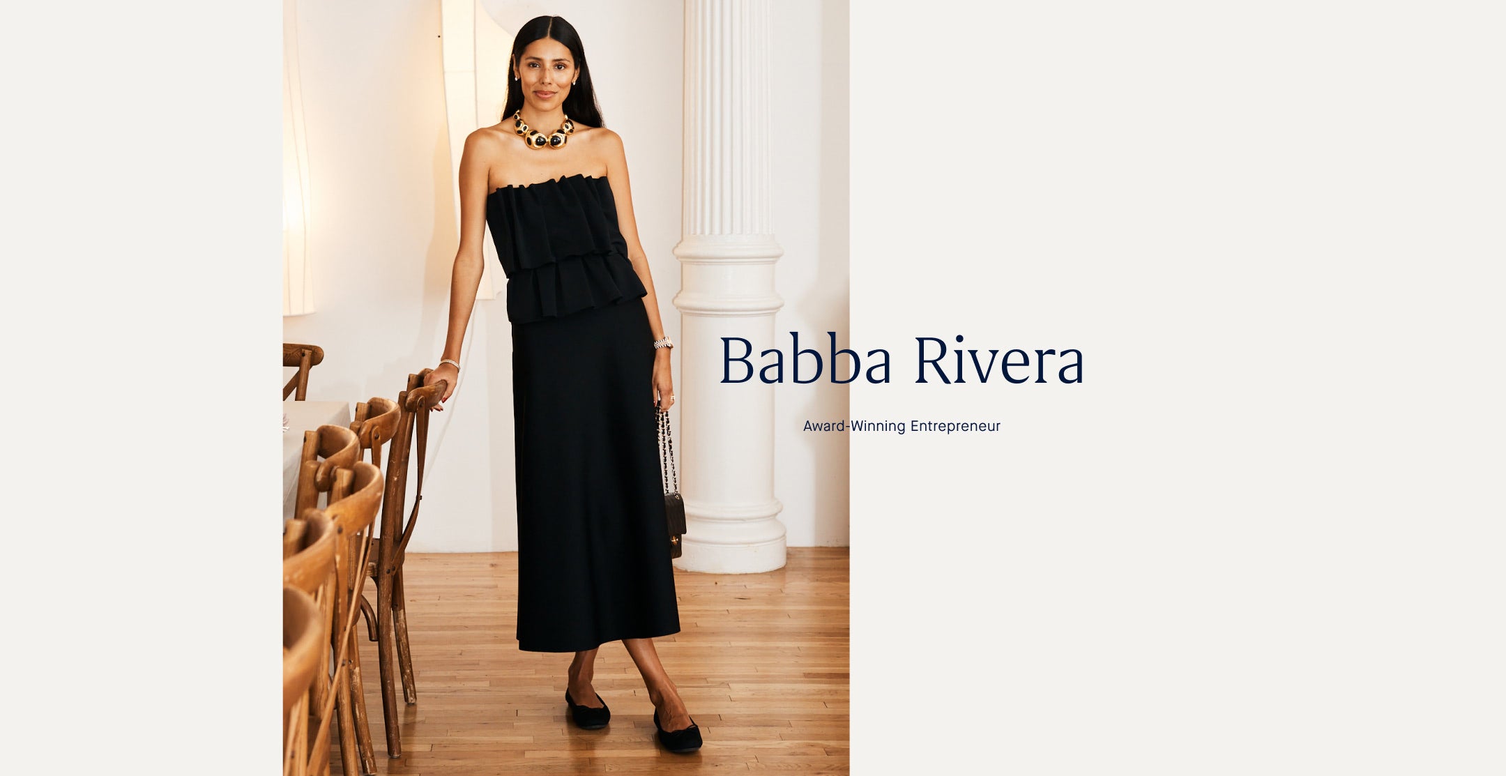 Woman in a black Point flats standing in a room with columns, wearing a necklace, with 'Babba Rivera'.