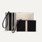 The Wallet Wristlet in Black Portobello Stripe, shown in comparison with The Wristlet—in Ivory Rugby Stripe—for scale.