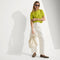 Alternate view of The Mini Zip Bucket in White Sand worn by a female model.