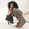 hover | Overlay:: Shown with The Shoulder Strap (sold separately.) | Alt:: The Daily Crossbody in Black Sand paired with The Shoulder Strap in Black being carried by a model.