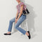Alternate view of The Casual Crossbody in Black & Ivory Stripe, worn as a crossbody by a model, shown from the side. 