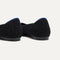 Close up of the heel of The Point II in Black Bouclé, with Rothy's signature blue halo. 