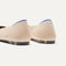 Close up of the heel of The Point II in Ecru, with Rothy's signature blue halo. 