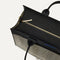 The Classic Tote in Black Herringbone, shown from above, with the top zipper closed. 