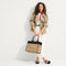 Alternate view of the Classic Tote in Tiramisu, worn over by a model.