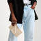 hover | The Wallet Wristlet in Vanilla Basketweave, held by a model, shown from the front.