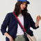 hover | Overlay:: Shown with The Crescent Bag (sold separately.) | Alt:: The Crossbody Strap in Navy & Red, shown paired with The Crescent Bag, worn by a model, shown from the side