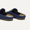 Close up of the heel of The Double Bit Loafer Mule in Blue Raffia-Knit, with Rothy's signature blue halo. 