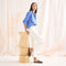 Alternate view of a model wearing The Double Bit Loafer Mule in Cinnamon Raffia-Knit. 