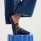 hover | Model wearing The Double Bit Loafer Mule in Blue Raffia-Knit. 