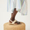 hover | Model wearing The T-Strap Sandal in Cream Puff. 