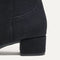 Close up of the block heel of The Classic Boot in Black.