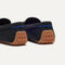 Close up of the heel of The Double Bit Driver in Black, with raised nub outsoles and Rothy's signature blue halo. 