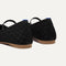 Close up of the heel of The Max Square Mary Jane in Black Sand, with Rothy's signature blue halo.