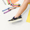 hover | Model wearing The Kids Sneaker in Spruce Camo.