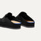 Close up of the heel of The Men's Clog in Soft Black, with Rothy's signature blue halo. 