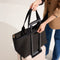 hover | Model holding The Zip Travel Tote in Night Song.
