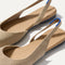 Close up of the strap on The Almond Slingback in Metallic Prosecco, with Rothy's signature blue halo.