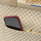 A close up of The Zip Travel Tote in Parchment Basketweave with a phone slipped into the outer pocket.A close up of The Zip Travel Tote in Parchment Basketweave with a phone slipped into the outer pocket.