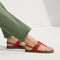 hover | Model wearing The T-Strap Sandal in Brick. 