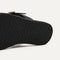 Close up of the outsole of The T-Strap Sandal in Black.