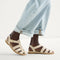 hover | Model wearing The Fisherman Sandal in Coconut. 