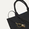 Close up of the handles and key leash detail of The Lightweight Tote in Black Licorice. 