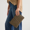 Model holding The Convertible Clutch in Toffee Chevron.