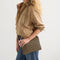 hover | Overlay::Shown with The Shoulder Strap. Sold separately. | Alt::Actual alt text The Convertible Clutch in Toffee Chevron.
