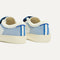 Close up of the heel of The Kids Strap Sneaker in Blue Raspberry, with Rothy's signature blue halo. 