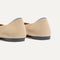 Close up of the heel of The Daily Flat in Ecru, with Rothy's signature blue halo. 