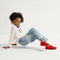 Alternate view of a model wearing The Kids Clog in Firetruck Red. 
