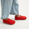hover | A child wearing The Kids Clog in Firetruck Red. 
