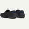 Close up of the heel of The Men's Daily Driver in Black, with raised peg outsoles and Rothy's signature blue halo. 