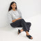 Alternate view of a model wearing The Weekend Sandal in Black. 