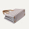 The Classic Tote in Watermelon Market Stripe, shown from the bottom. 