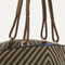 A close up of The Summer Tote in Toffee Chevron focusing on the pocket and handles.