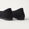 Close up of the heel of The Max Square Ballerina in ReVelvet Black with Rothy's signature blue halo.