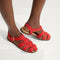 hover | Model wearing The Fisherman Sandal in Scarlet. 