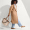 hover | Overlay:: Shown with The Crossbody Strap (sold separately.) | Alt:: An alternate view of a model holding The Lightweight Zip Tote in Vanilla Wafer paired with The Crossbody Strap in Desert Cat. 