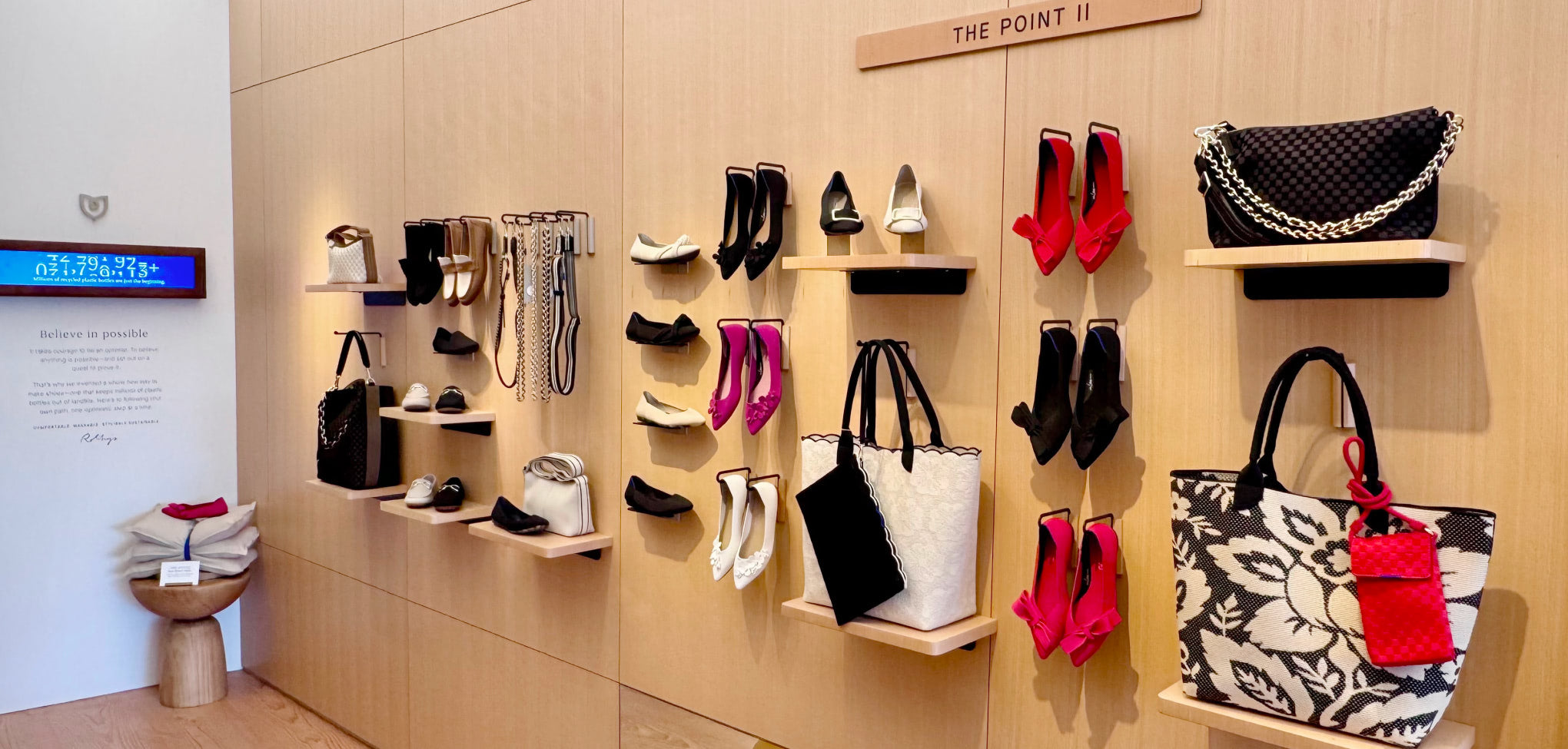 othy's interior store Shoe and handbag display in a store with wooden shelves.