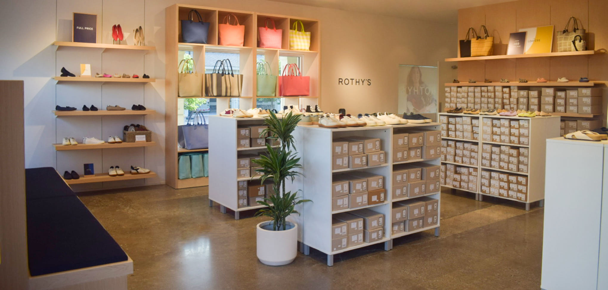 Rothy's interior store with shelves displaying bags and products, featuring the brand 'Rothy's'.