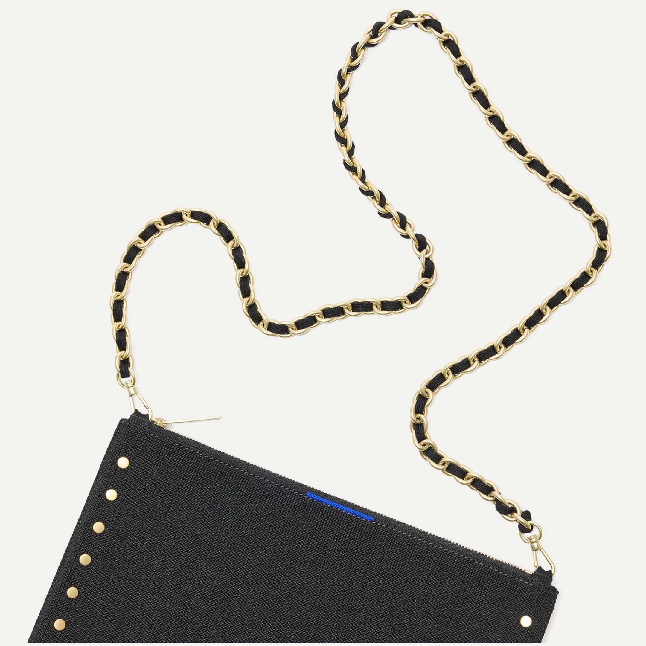 The Convertible Clutch Studded Black focusing on the chain.