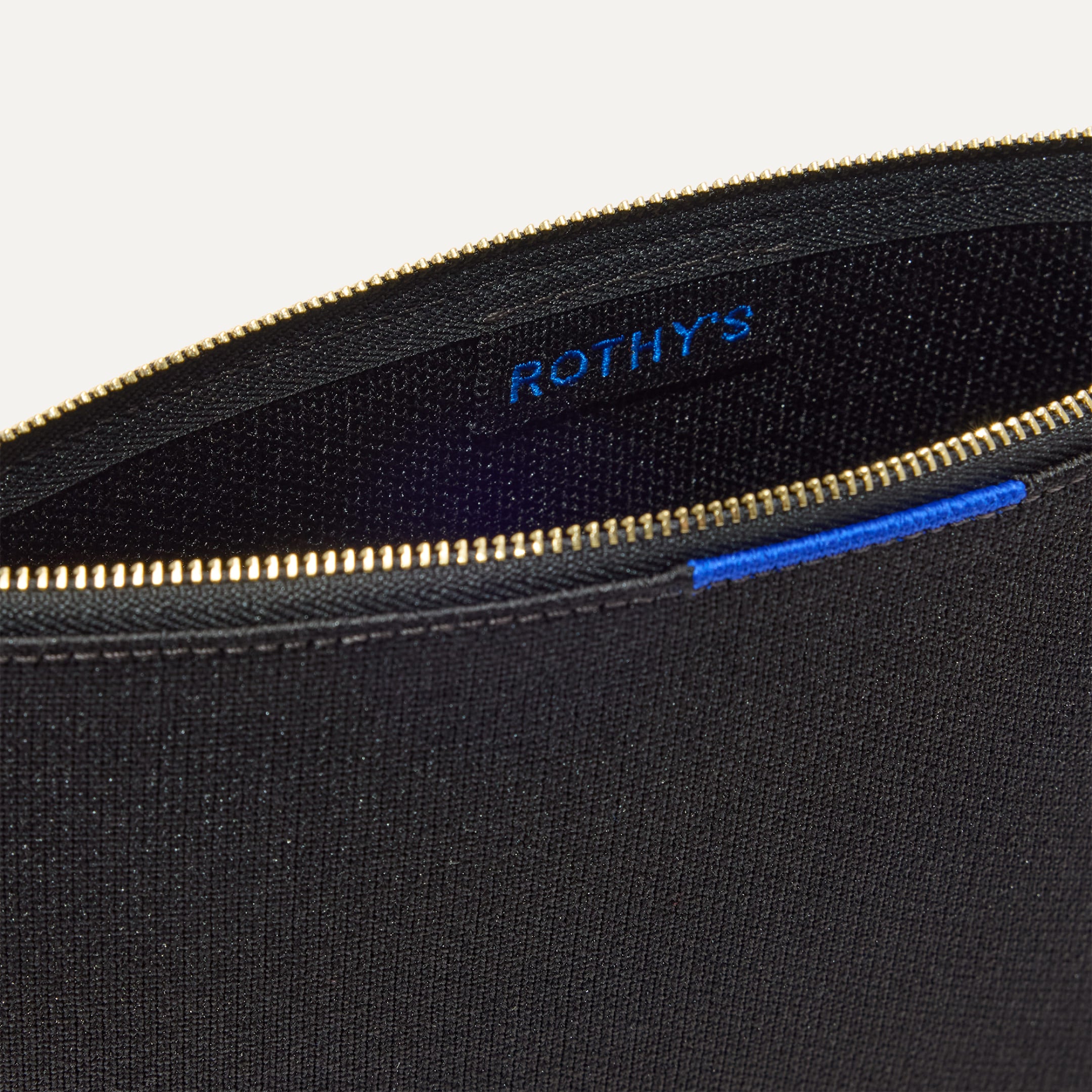 Close up of the interior of The Convertible Clutch Studded Black.
