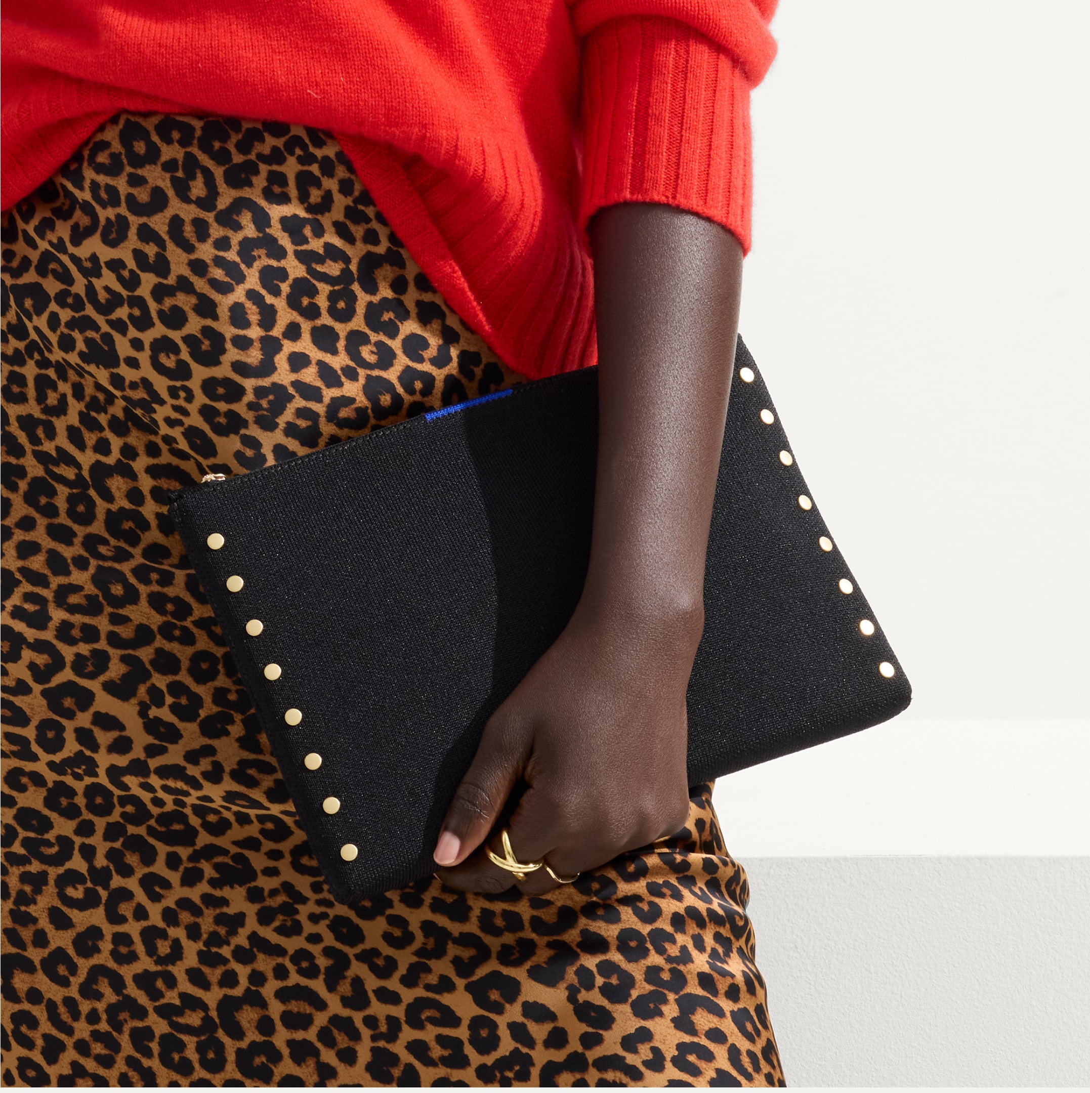 Model holding The Convertible Clutch	Studded Black.