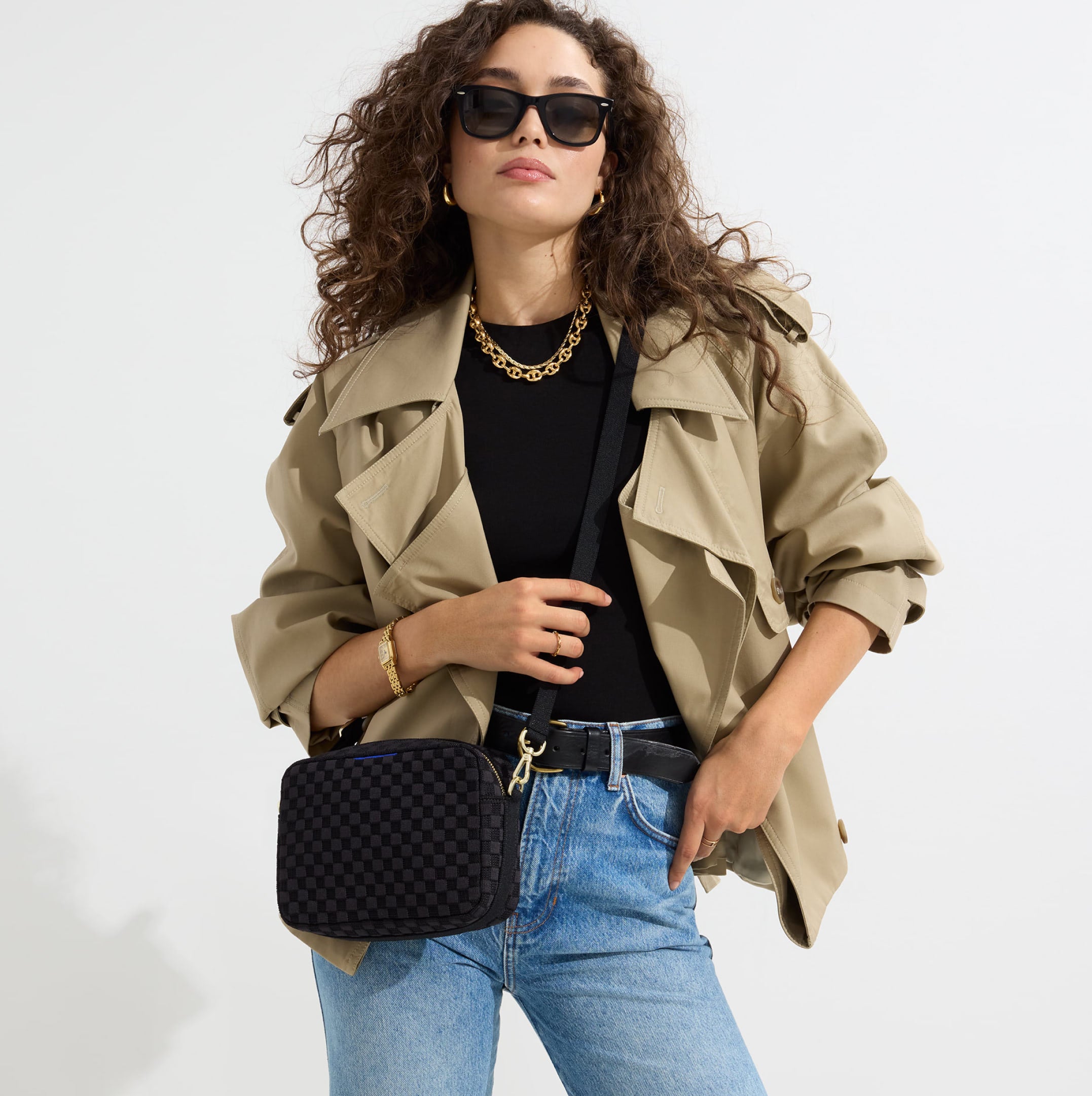 Model wearing The Crossbody Camera Bag in Black Sand.